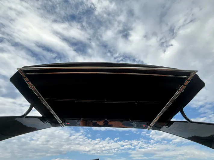  Yacht Photos Pics 2022 Cruisers Yachts 338 CX SB canopy against a cloudy sky backdrop.