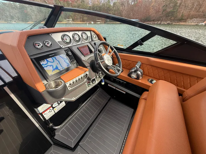  Yacht Photos Pics 2022 Cruisers Yachts 338 CX SB helm with navigation system and luxurious seating.