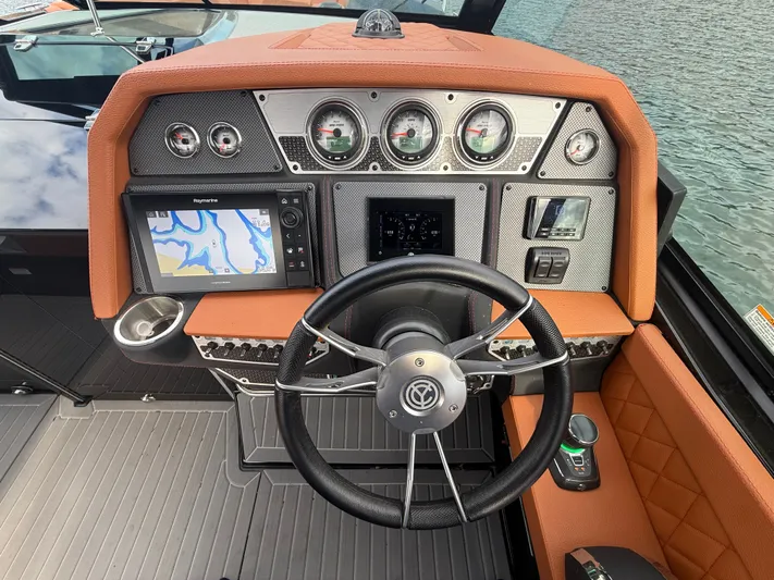  Yacht Photos Pics 2022 Cruisers Yachts 338 CX SB helm with navigation display and gauges.
