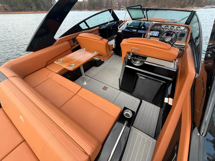  Yacht Photos Pics Luxurious 2022 Cruisers Yachts 338 CX SB interior with tan seating and modern dashboard.