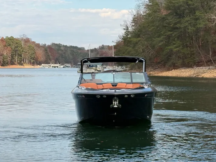  Yacht Photos Pics 2022 Cruisers Yachts 338 CX SB on a serene lake with forested shoreline.