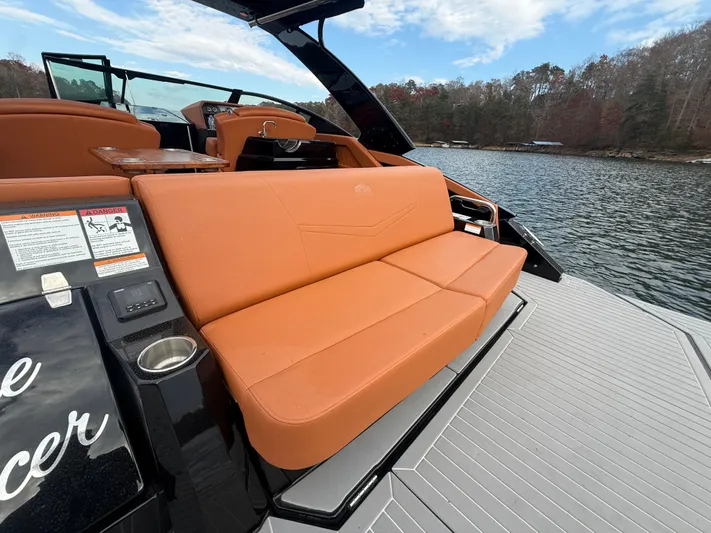  Yacht Photos Pics 2022 Cruisers Yachts 338 CX SB with orange seating, docked on a serene lake.