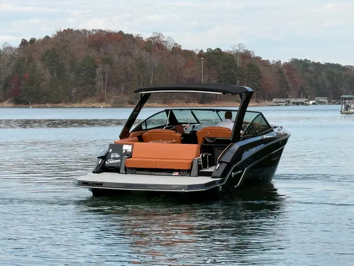 Yacht Photos Pics 2022 Cruisers Yachts 338 CX SB on a serene lake with forested background.