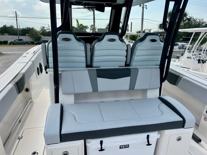  Yacht Photos Pics 2025 Robalo R300 boat interior with cushioned seating and Yeti cooler.