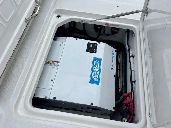  Yacht Photos Pics 2025 Robalo R300 boat storage compartment with electrical equipment and wiring.