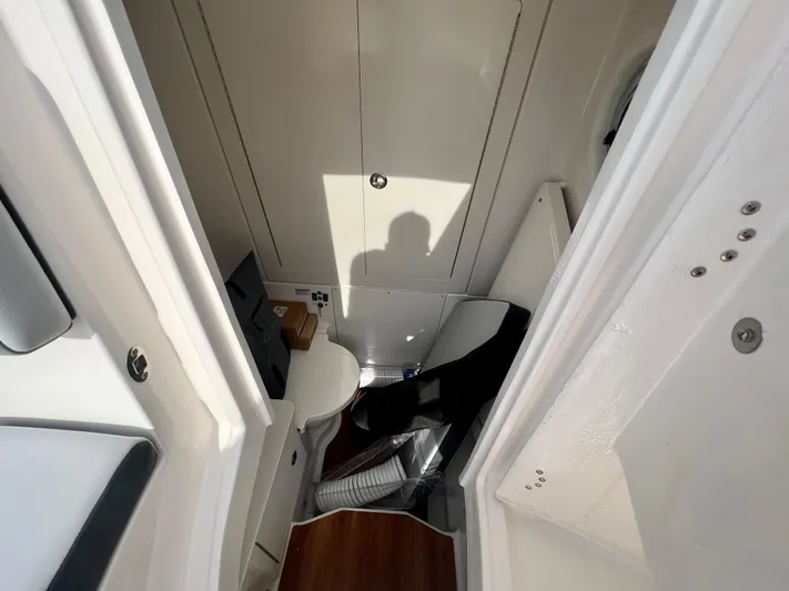  Yacht Photos Pics 2025 Robalo R300 boat interior with compact bathroom and modern design.