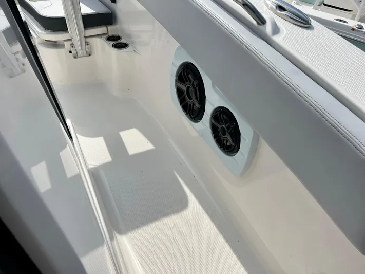 Yacht Photos Pics 2025 Robalo R300 boat interior with dual speakers and seating area.