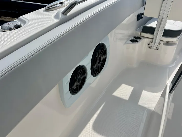  Yacht Photos Pics 2025 Robalo R300 boat interior with speakers and seating area.