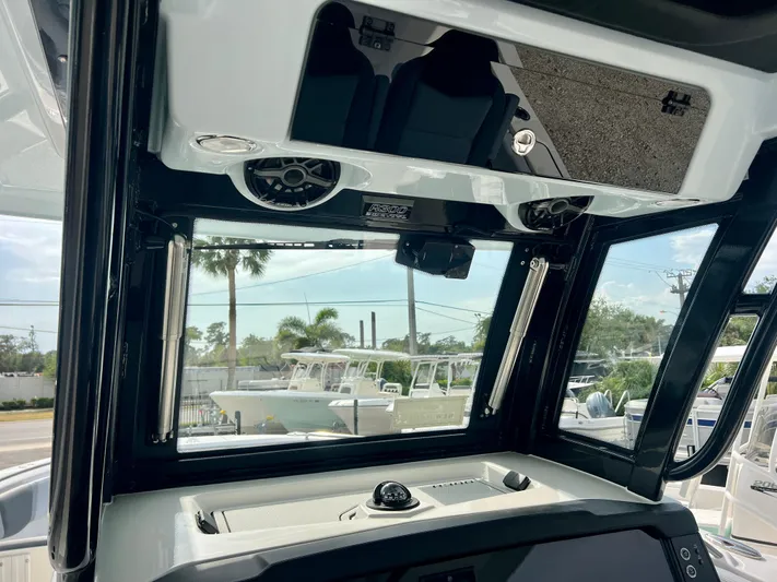  Yacht Photos Pics Interior view of 2025 Robalo R300 boat cockpit with modern controls and speakers.