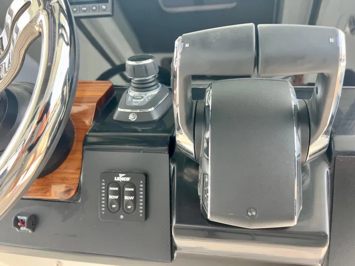  Yacht Photos Pics Control panel of 2025 Robalo R300 boat with steering wheel and throttle.