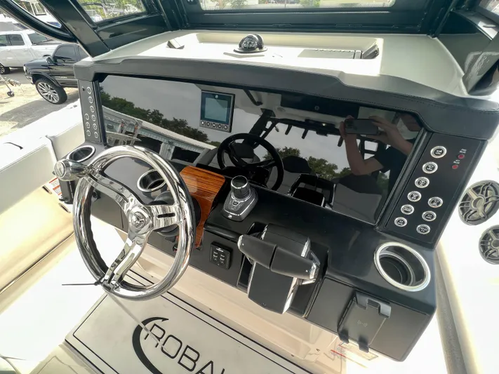  Yacht Photos Pics 2025 Robalo R300 boat dashboard with steering wheel, controls, and digital display.