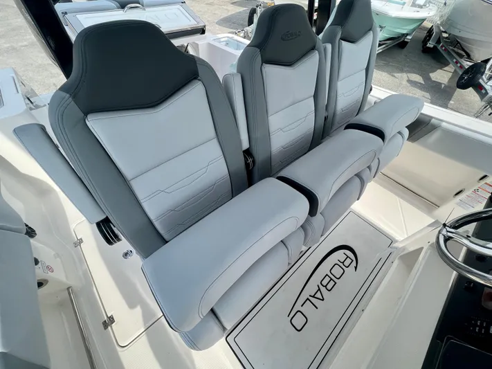  Yacht Photos Pics 2025 Robalo R300 boat interior with sleek, modern seating and branded floor mat.