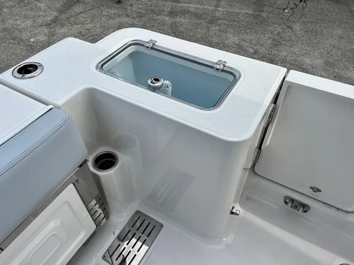  Yacht Photos Pics 2025 Robalo R300 boat interior with livewell and storage compartments.