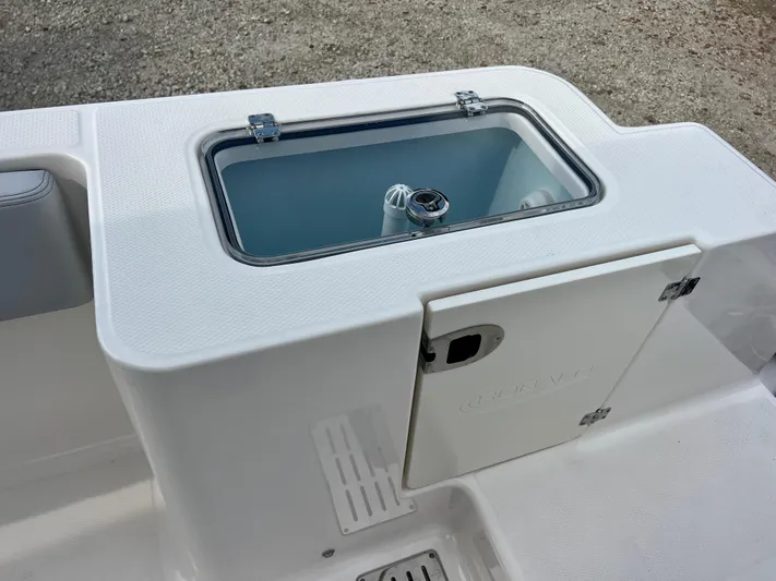  Yacht Photos Pics 2025 Robalo R300 boat livewell and storage compartment, featuring a sleek white design.