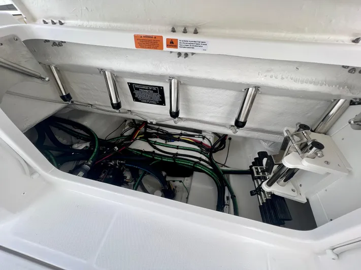  Yacht Photos Pics 2025 Robalo R300 boat storage compartment with hydraulic systems and wiring.