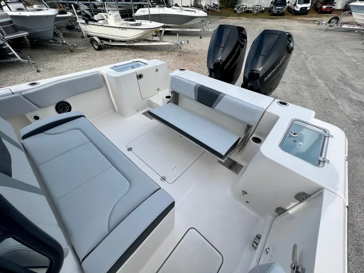  Yacht Photos Pics 2025 Robalo R300 boat interior with seating, storage, and dual outboard motors.