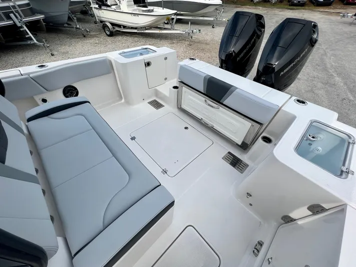  Yacht Photos Pics 2025 Robalo R300 boat interior with seating, storage, and dual outboard engines.