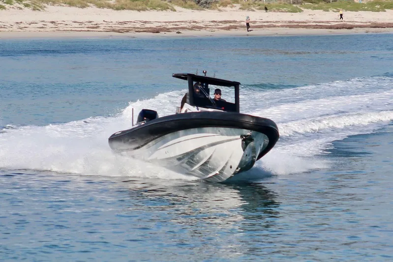  Yacht Photos Pics 2026 Northstar ION 12 boat speeding on water near sandy beach.