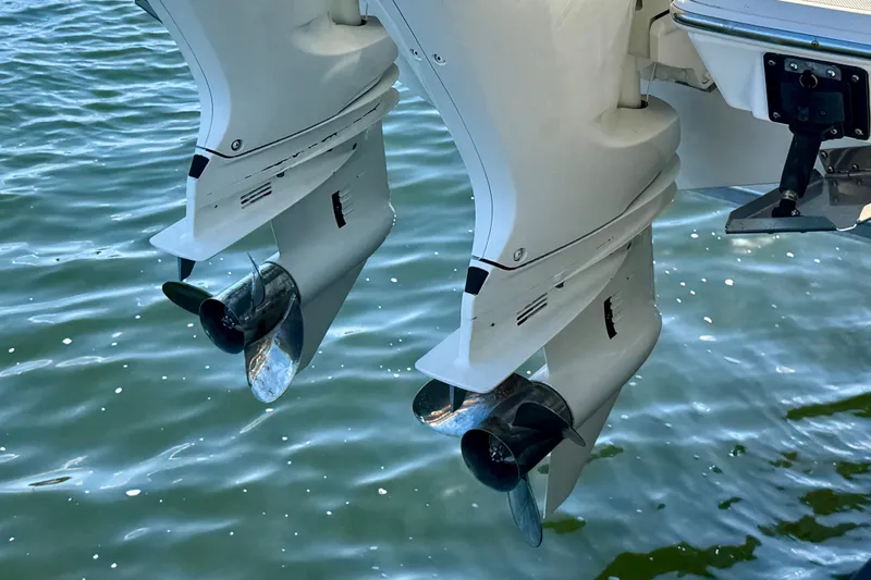  Yacht Photos Pics 2020 Pursuit DC 266 Dual Console boat engines over water.