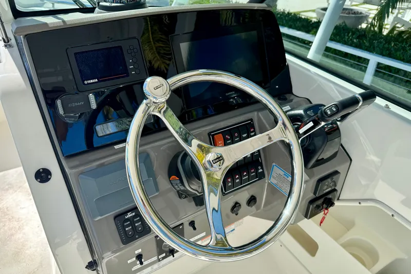  Yacht Photos Pics 2020 Pursuit DC 266 Dual Console boat dashboard with steering wheel and controls.
