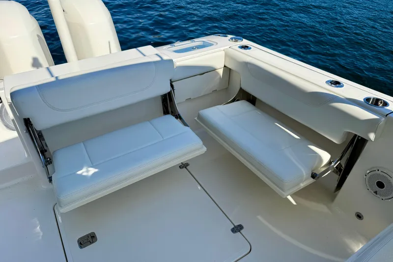  Yacht Photos Pics 2020 Pursuit DC 266 Dual Console boat with white seating, on calm blue water.