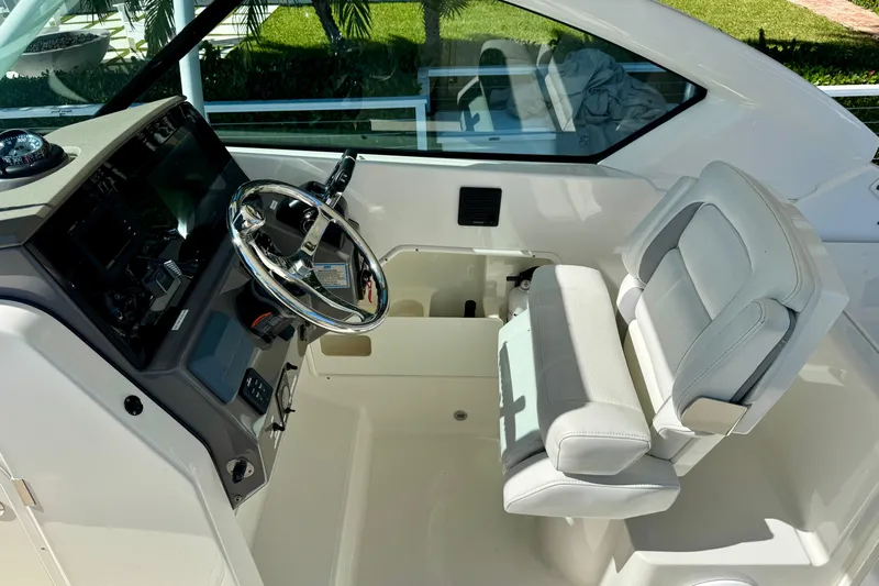  Yacht Photos Pics 2020 Pursuit DC 266 Dual Console boat interior with steering wheel and seating.