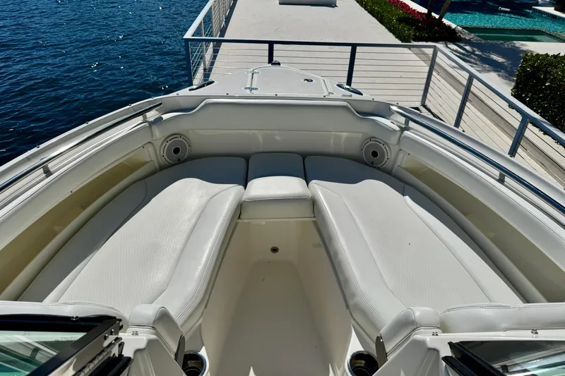  Yacht Photos Pics 2020 Pursuit DC 266 Dual Console boat with white seating, docked by the water.