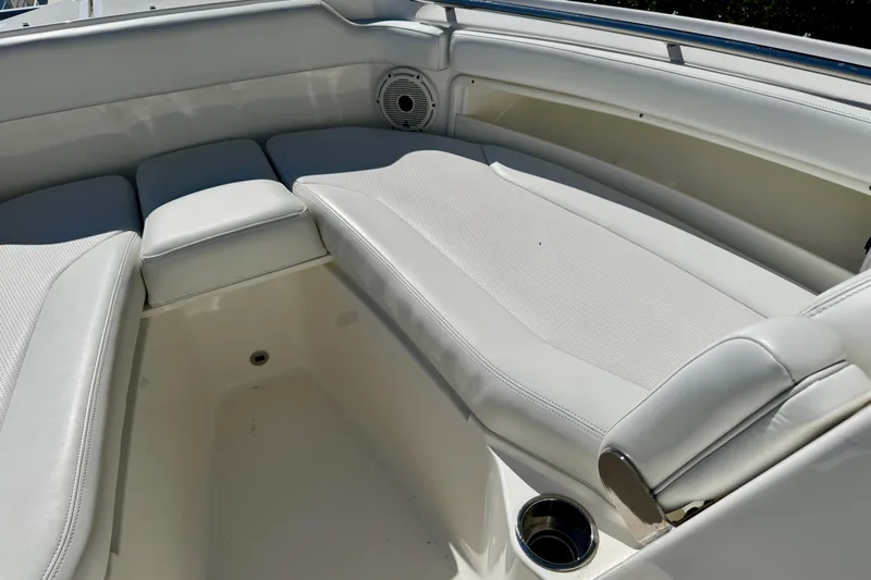  Yacht Photos Pics 2020 Pursuit DC 266 Dual Console boat interior with cushioned seating and cup holder.