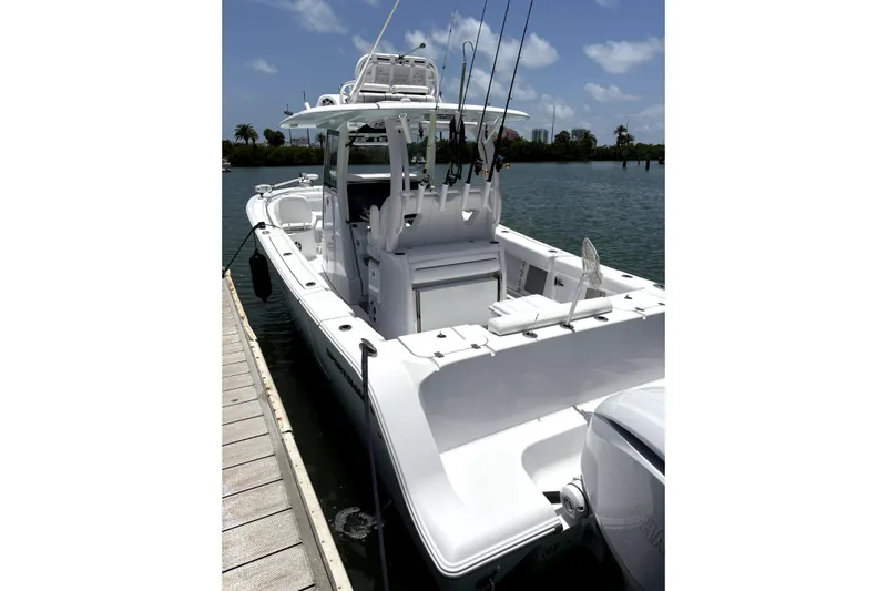  Yacht Photos Pics 2024 Sportsman Open 302 Center Console boat docked on a sunny day.