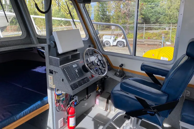 Apollo Axon Yacht Photos Pics Interior of 2007 Armstrong Marine Catamaran cockpit with steering wheel and control panel.