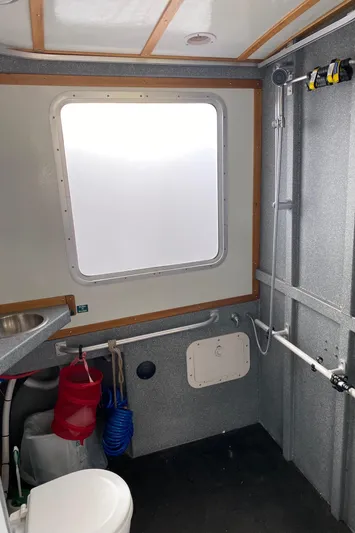 Apollo Axon Yacht Photos Pics Interior of 2007 Armstrong Marine Catamaran bathroom with window, shower, and sink.