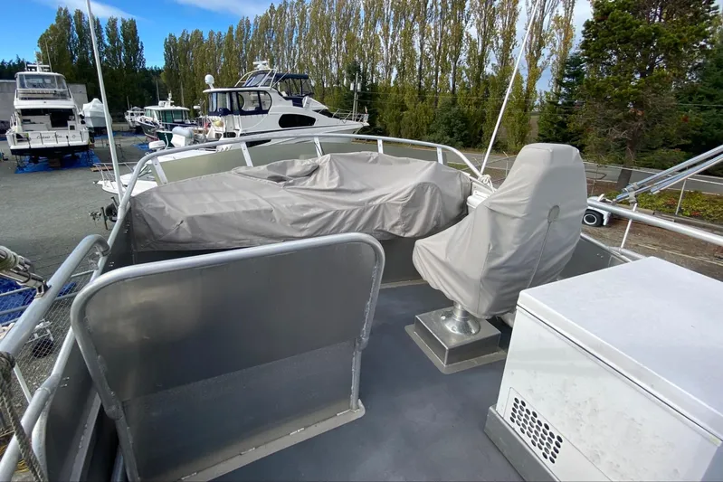 Apollo Axon Yacht Photos Pics 2007 Armstrong Marine Catamaran deck with covered seating and helm, surrounded by boats.