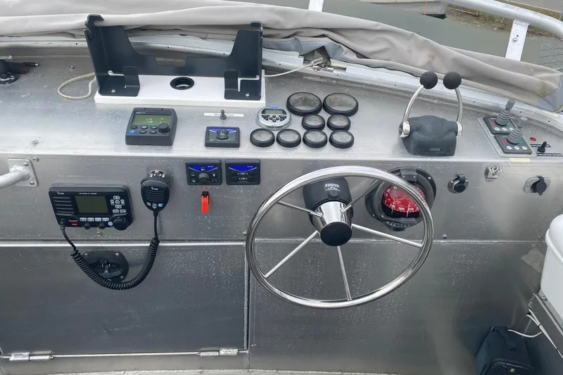 Apollo Axon Yacht Photos Pics 2007 Armstrong Marine Catamaran helm with steering wheel, gauges, and communication equipment.