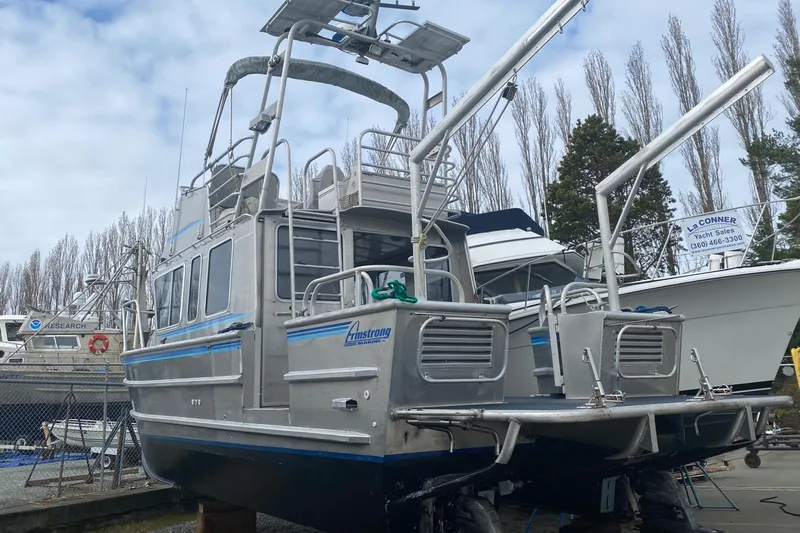 Apollo Axon Yacht Photos Pics 2007 Armstrong Marine Catamaran docked, featuring dual hulls and elevated deck.