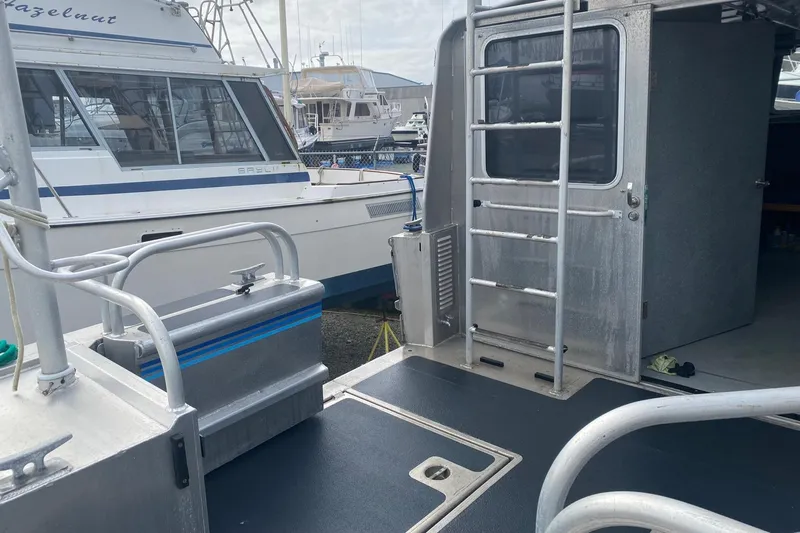 Apollo Axon Yacht Photos Pics 2007 Armstrong Marine Catamaran docked, featuring a sleek aluminum deck and ladder.