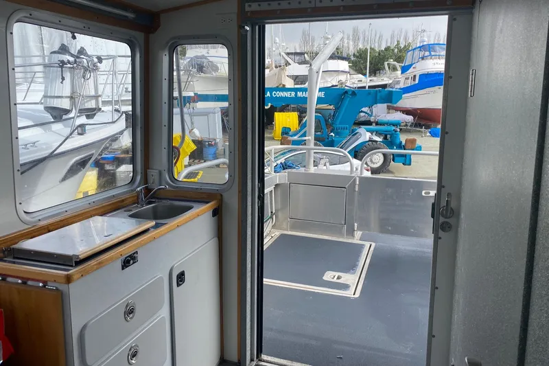 Apollo Axon Yacht Photos Pics Interior view of 2007 Armstrong Marine Catamaran with sink and outdoor deck access.