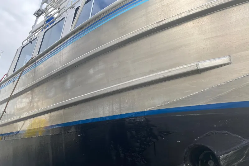 Apollo Axon Yacht Photos Pics 2007 Armstrong Marine Catamaran with sleek metallic hull and blue accents.