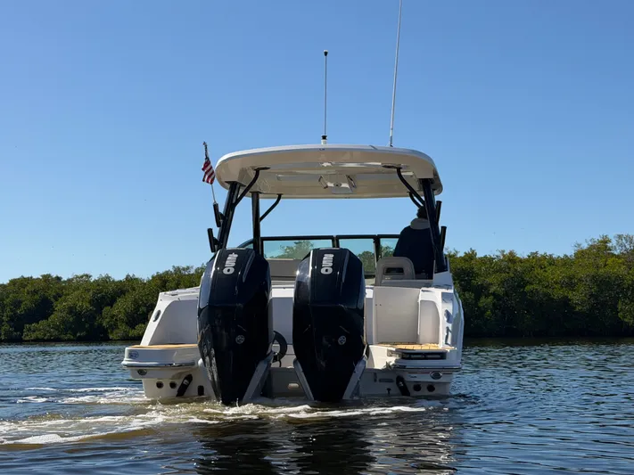  Yacht Photos Pics Boston Whaler 280 Vantage 2022 on calm water with dual outboard engines.