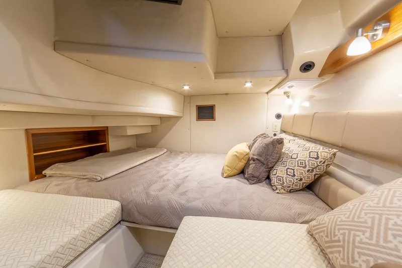  Yacht Photos Pics Manufacturer Provided Image: Cozy cabin interior of 2025 Ranger Tugs R-43 CB with plush bedding and ambient lighting.
