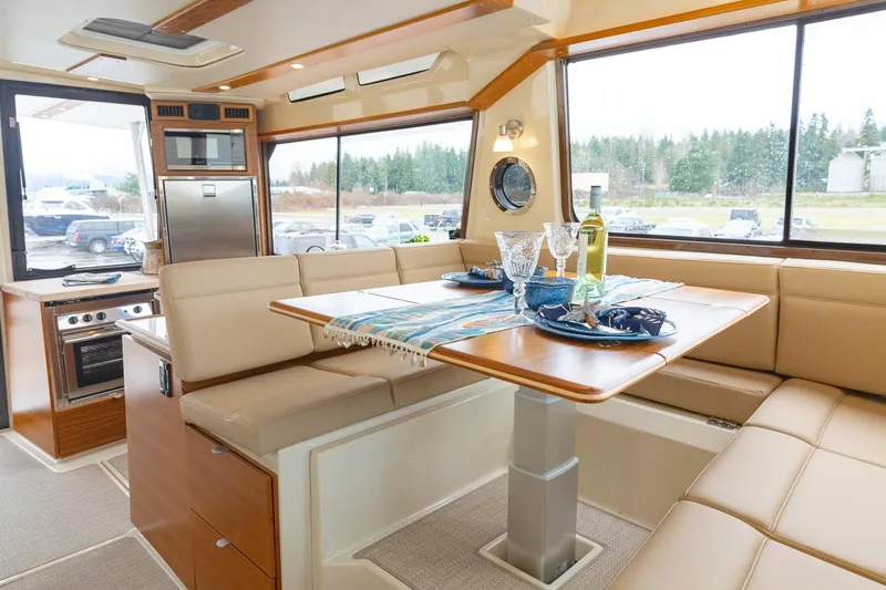  Yacht Photos Pics Manufacturer Provided Image: Luxurious interior of 2025 Ranger Tugs R-43 CB with dining area and modern kitchen.