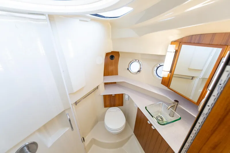  Yacht Photos Pics Manufacturer Provided Image: Luxurious bathroom in 2025 Ranger Tugs R-43 CB yacht with modern fixtures and porthole windows.