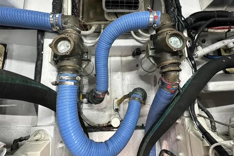  Yacht Photos Pics Engine room of 2006 Sea Ray 580 Sedan Bridge with blue hoses and mechanical components.