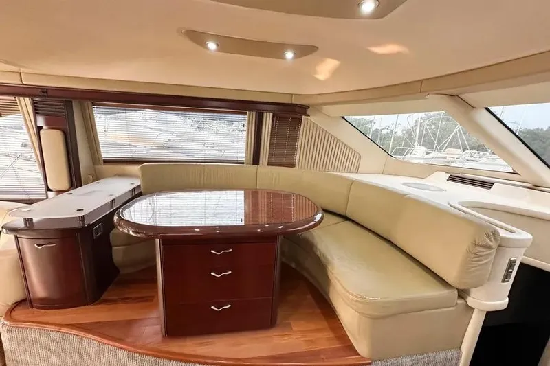  Yacht Photos Pics Luxurious interior of 2006 Sea Ray 580 Sedan Bridge yacht with elegant seating and table.
