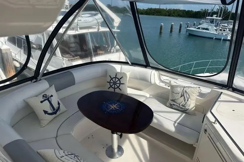  Yacht Photos Pics Luxurious 2006 Sea Ray 580 Sedan Bridge interior with nautical-themed cushions and waterfront view.