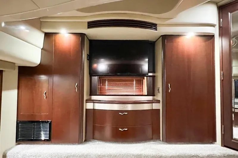  Yacht Photos Pics Luxurious interior of 2006 Sea Ray 580 Sedan Bridge with wood cabinetry and TV.