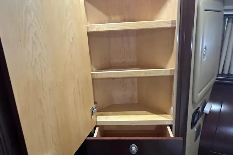  Yacht Photos Pics Open wooden cabinet with shelves inside a 2006 Sea Ray 580 Sedan Bridge.