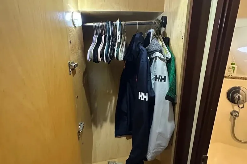  Yacht Photos Pics Closet with jackets and hangers inside a 2006 Sea Ray 580 Sedan Bridge yacht.