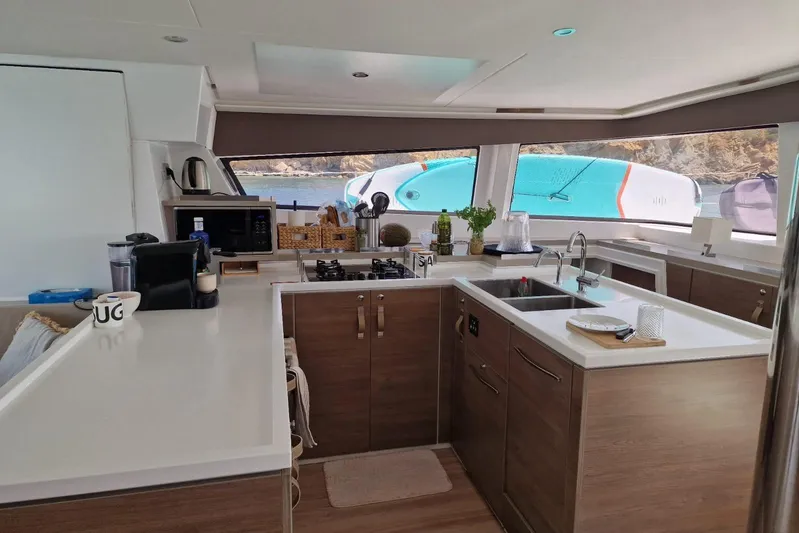 Only One Life Yacht Photos Pics Modern kitchen interior of 2022 Bali 5.4 Open Space yacht with ocean view.