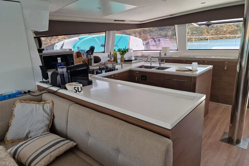 Only One Life Yacht Photos Pics Luxurious interior of 2022 Bali 5.4 Open Space yacht with modern kitchen and scenic view.