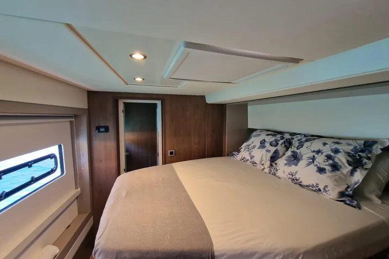 Only One Life Yacht Photos Pics Luxurious bedroom interior of 2022 Bali 5.4 Open Space yacht with floral bedding.